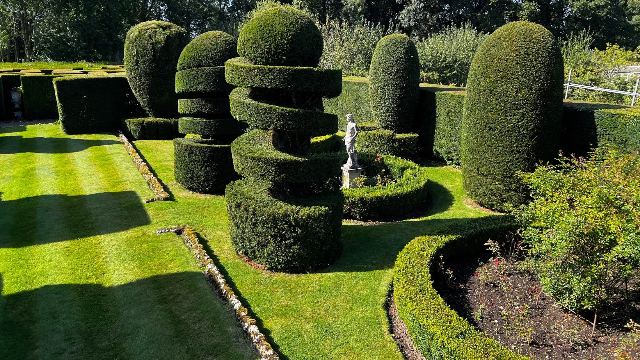 Yew topiary spirals and clipped forms maintained by Gemzas Garden Maintenance and Landscaping in a formal Sevenoaks garden