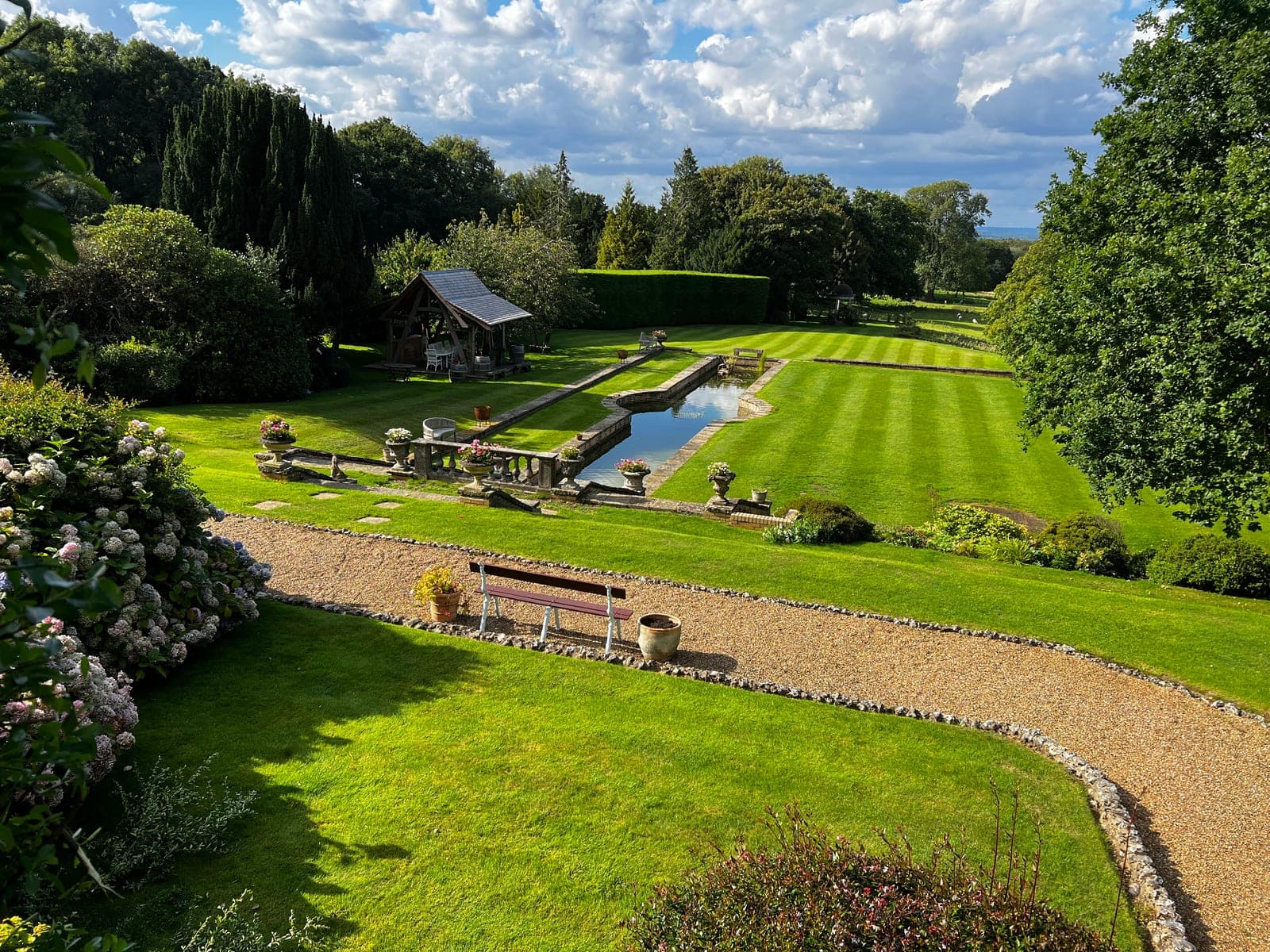 Formal Sevenoaks grounds maintained by Gemzas Garden Maintenance and Landscaping with striped lawns, clipped hedges and ornamental pool
